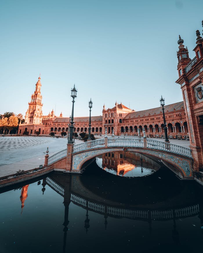 Explore the beautiful architecture of Plaza de España in Seville, Spain during sunrise.