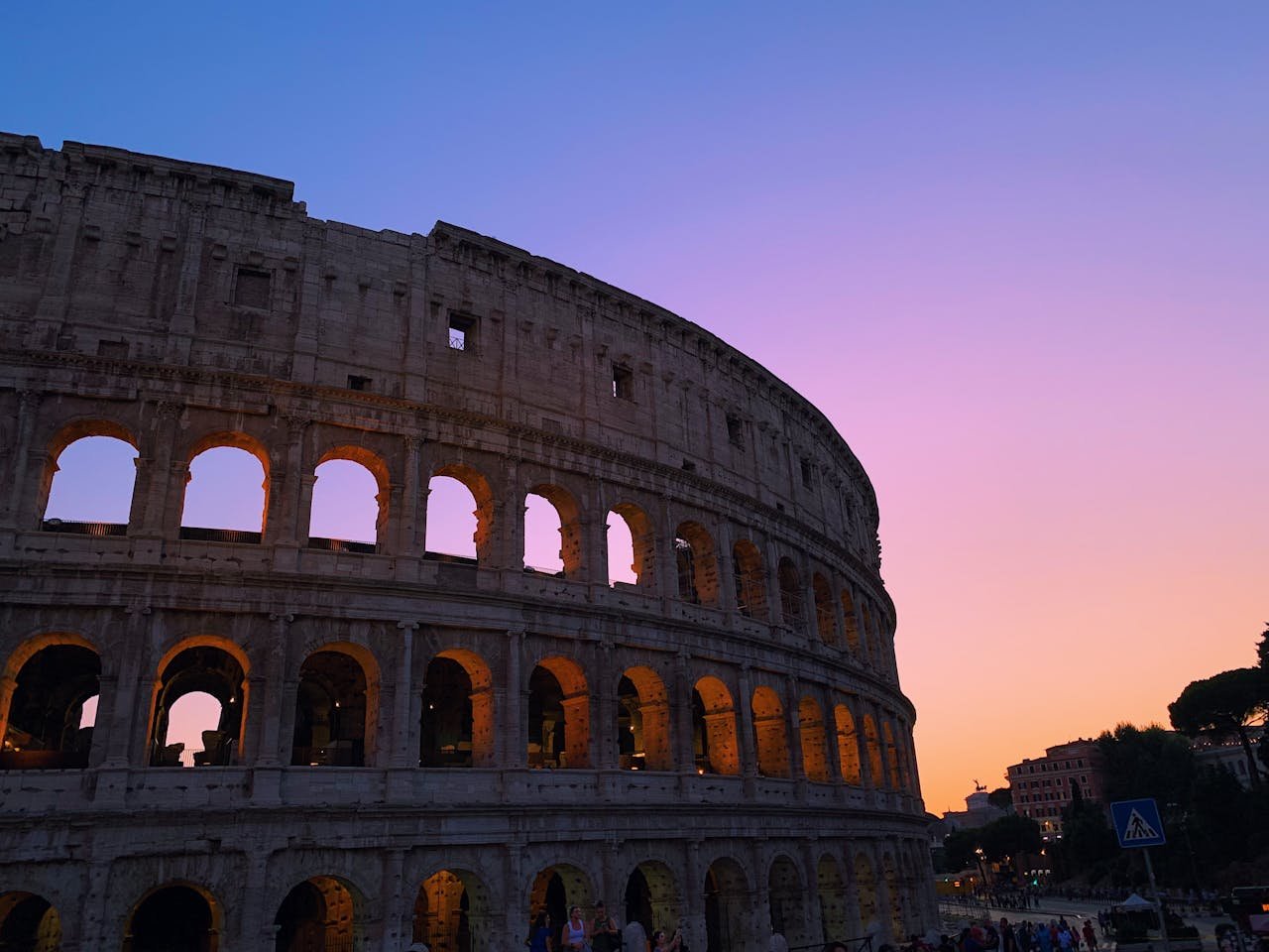 journey-02 Stunning sunset over the Colosseum in Rome with vibrant colors highlighting the ancient architecture.